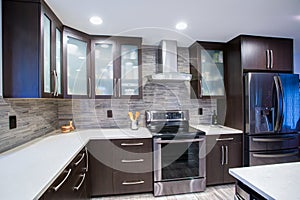 Updated contemporary kitchen room interior in white and dark tones. photo