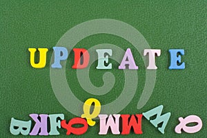 UPDEATE word on green background composed from colorful abc alphabet block wooden letters, copy space for ad text