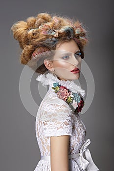 Updo. Dyed Hair. Woman with Modern Hairstyle. High Fashion photo