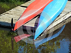 Upended canoes drying out on wooden pier