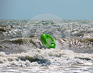 Upheaval of children's inflatable circle on the wave photo