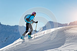 Uphill girl with seal skins and ski mountaineering photo