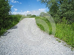 Uphill gravel road in summer