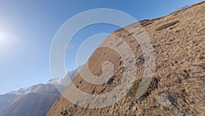 Uphill speed race mountain motorbike sports man riding up slope to summit at sunny sky aerial view