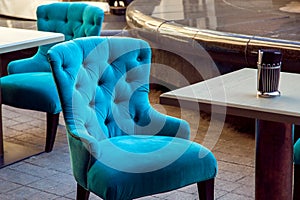 Upholstered armchair with fabric covering.