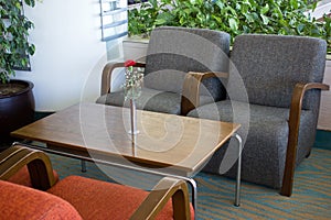 Upholstered furniture in the hotel lobby. Gray armchairs, wooden