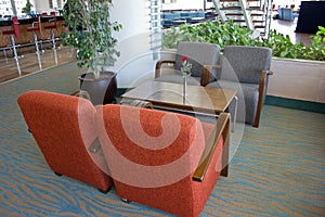 Upholstered furniture in the hotel lobby. Gray armchairs, wooden