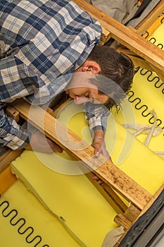 Upholsterer padding a sofa