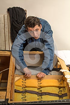 Upholsterer padding a sofa