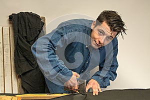 Upholsterer padding a sofa