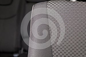 Upholstery of the seats of the passenger compartment of a luxury car with black fabric material in a workshop for hauling vehicles