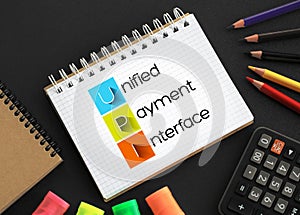 UPI - Unified Payment Interface acronym on notepad, business concept background