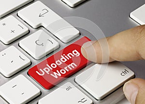 Uploading worm - Inscription on Red Keyboard Key photo