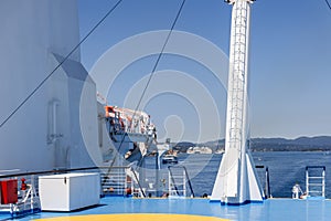 The upper blue and white observation deck of a passenger ferry plying in Europe, summer sunny clear morning