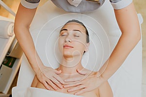 Upper chest massage of a woman laying down in spa