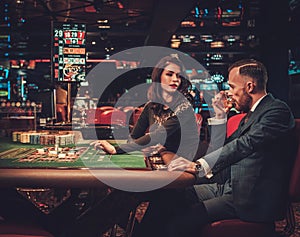 Upper class couple gambling in a casino