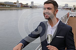 Upper class elegant man drinking champagne in private yacht