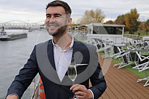 Upper class elegant man drinking champagne in private yacht