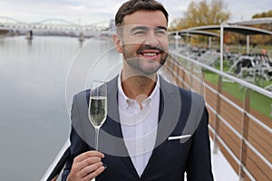 Upper class elegant man drinking champagne in private yacht