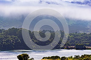 Upper Crystal Springs Reservoir,  part of the San Mateo Creek watershed and Santa Cruz mountains covered with clouds visible in