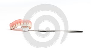 Upper dentures and dental mirror on white background