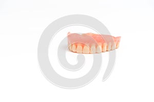 Upper dentures on white background