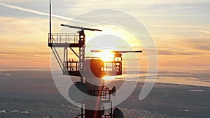 Upper ground of communication tower illuminated by sunset