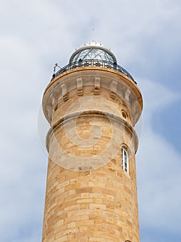 Chipiona lighthouse by day. You can see the upper part with the glass dome and the beacon. photo