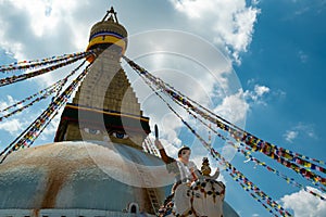 The upper part of the Boudhanath stupa in Kathmandu, Nepal. The image of Buddhas eyes on a gold surface of the stupa.