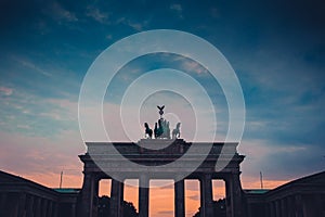 Upper part of brandenburg gate in berlin on a colorful evening with picturesque clouds. Colossal monument in berlin