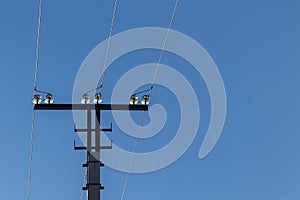 Upper part of a three-phase transmission line tower with insulators