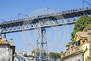 upper platform of the D.Luis bridge between the city of Porto and Vila Nova de Gaia. View from below, group of people and train.