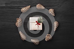 Upper, top view, of Christmas presents on a wooden black rustic background.