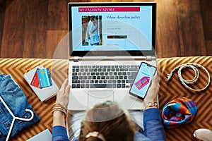 Woman browsing high fashion retail online store on laptop photo