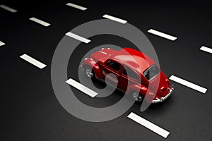 Upper view of  Red toy car on a road with road lane