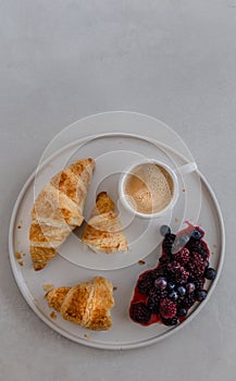 Upper view shot of a breakfast platter with coffee, croissants a