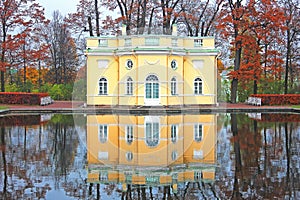 Upperbath pavilion in Tsarskoe selo park with reflection in water. Autumn view