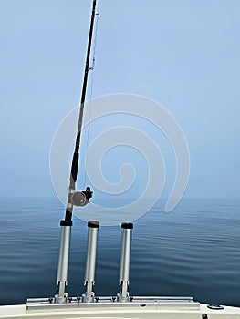 Upright Fishing Rod Holders on Boat with Pole and Lake Water