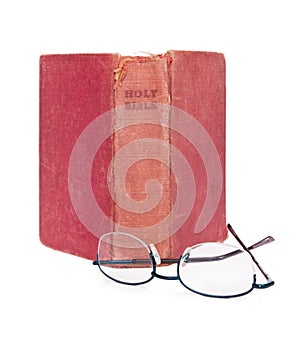 Upright Old Bible and Reading Glasses