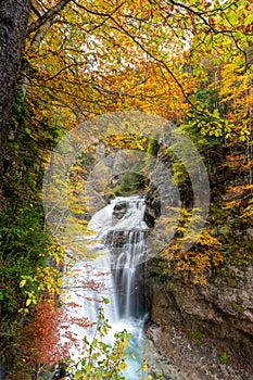 Upright photography of Cascada Del Estrecho  Estrecho waterfall during Autumn season,, in Ordesa valley  Heusca, Spain photo