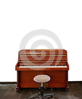 Upright piano and a stool isolated on white