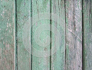 Upright striped wooden wall, fence, background with old threadbare green paint photo