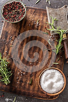 Upright top view empty cutting board after seasoning of meat that was taken away with cleaver, spices, herbs and salt