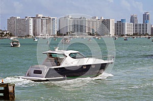 Upscale cabin cruiser and Miami Beach condo skyline