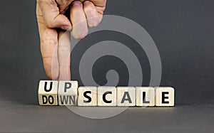 Upscale or downscale symbol. Concept words Upscale or Downscale on wooden cubes. Beautiful grey table grey background. Businessman