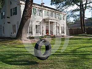 Upscale home with shaded front yard and swing