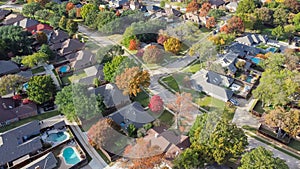 Upscale single family home with swimming pool and colorful fall foliage near Dallas, Texas, America