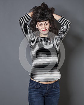 Upset 20s girl expressing embarassment with hair and hand gesture