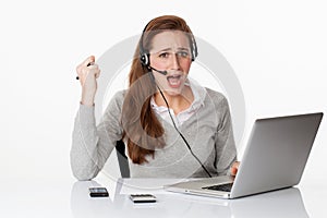 Upset 20s working woman with headset and computer,white office
