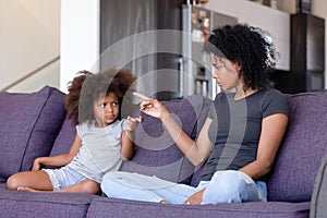 Upset African American mother and daughter quarreling at home